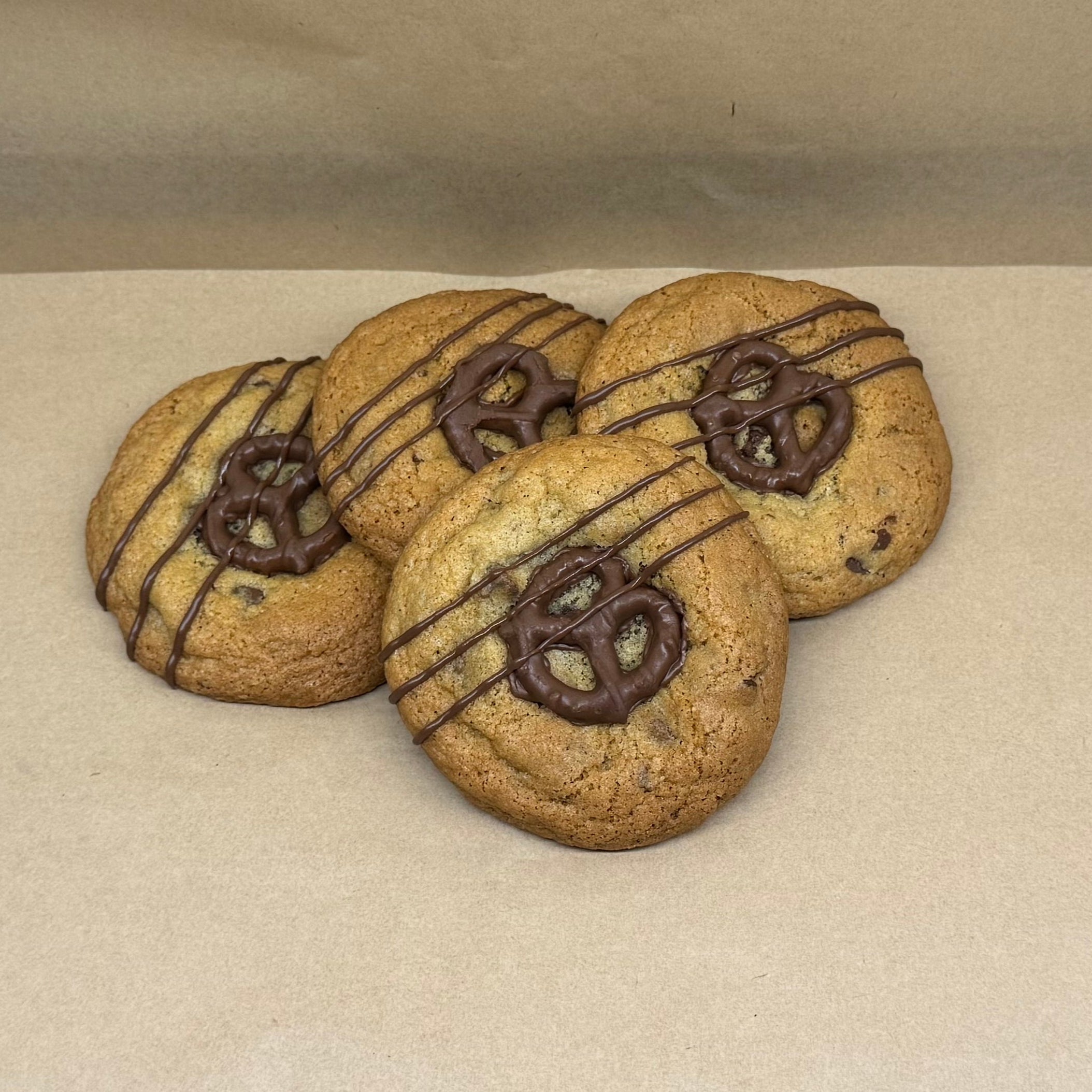 Three cookies with chocolate pretzel and drizzle on top.