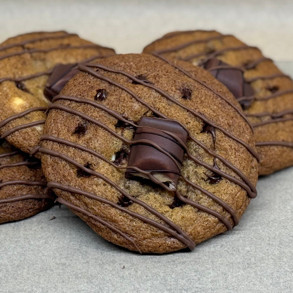 Kinder Bueno chocolate chip cookie topped with a Kinder Bueno Piece and milk chocolate drizzle.