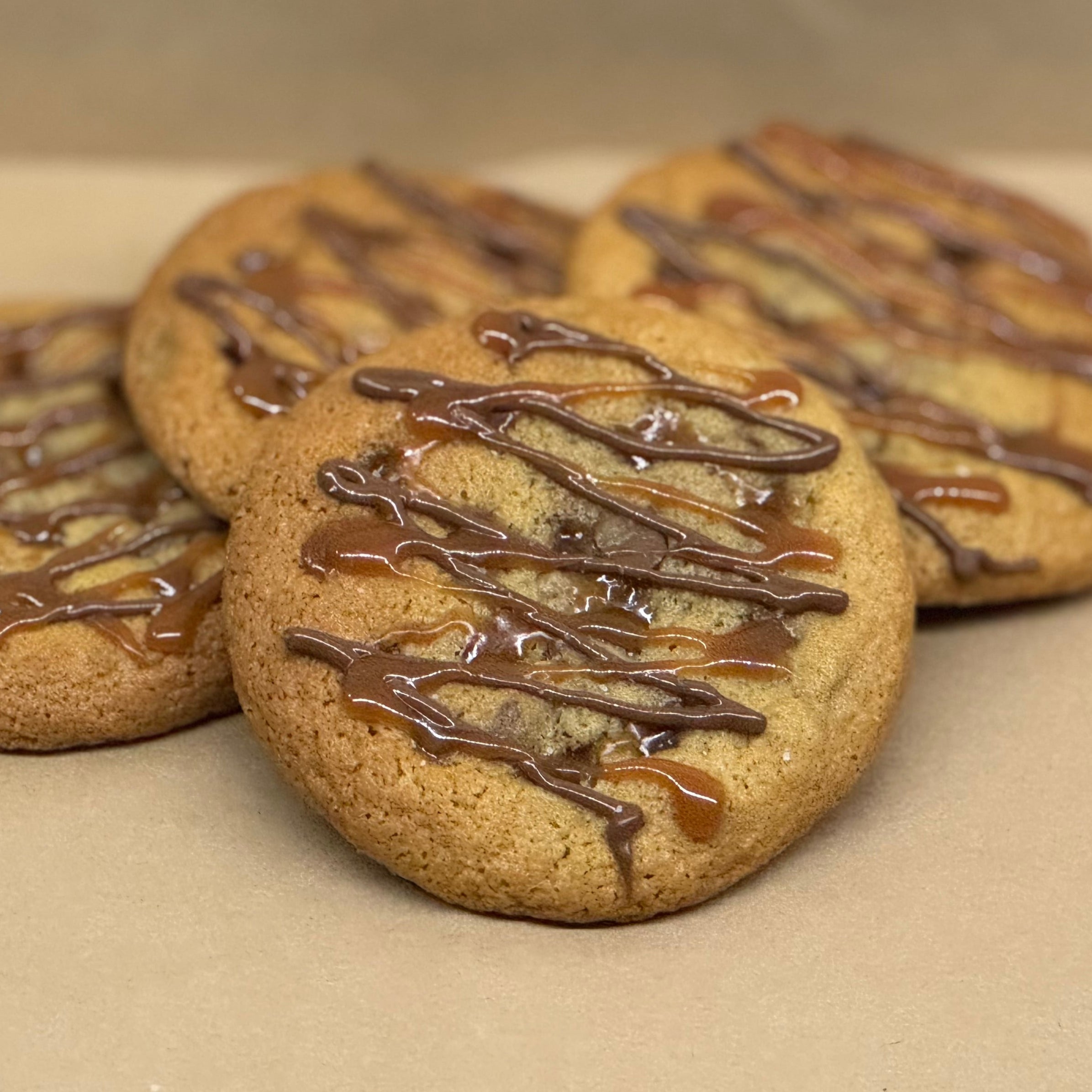 Salted caramel cookies with chocolate drizzle on top.