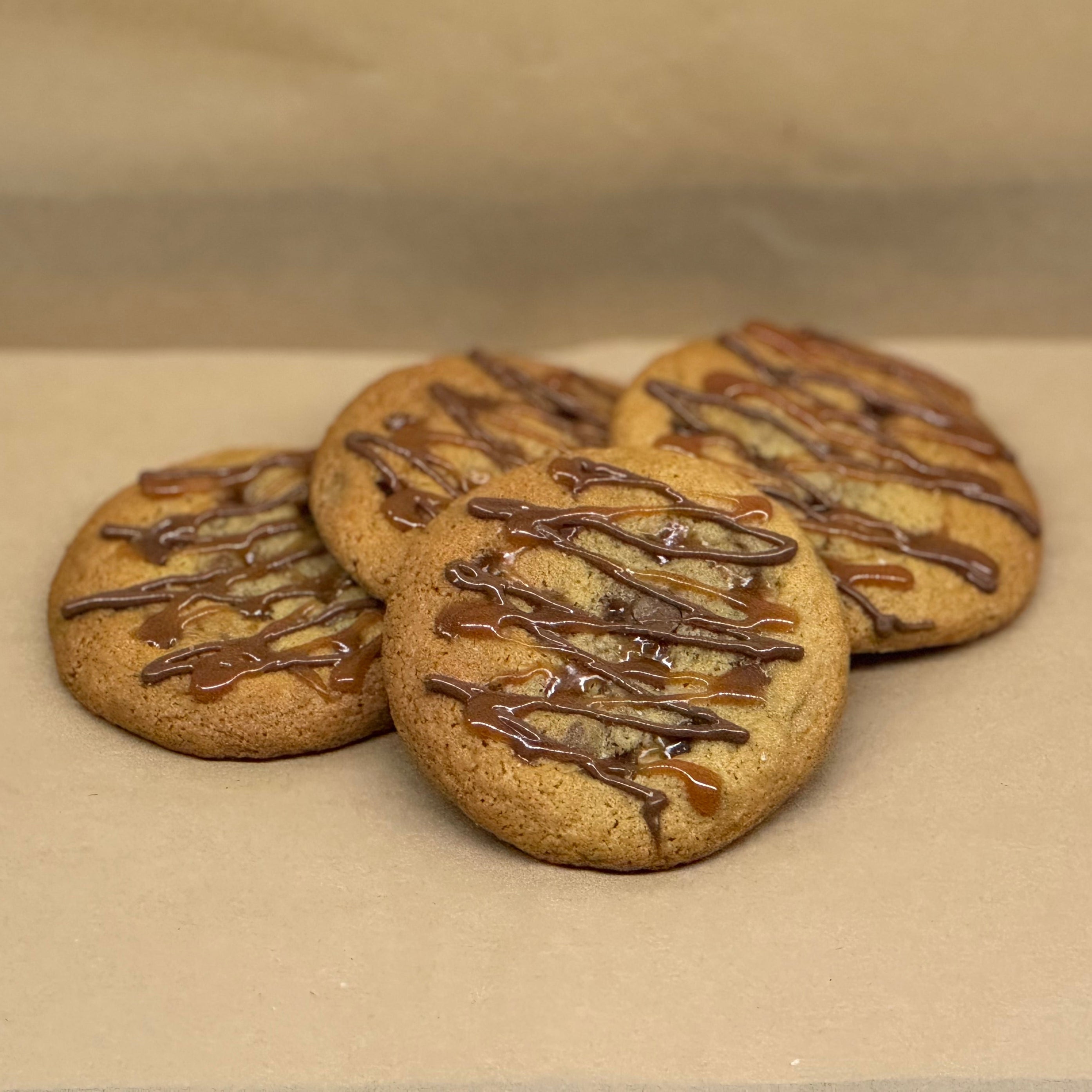 Cookies with chocolate drizzle and caramel sauce on top.